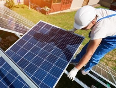 man-worker-firld-by-solar-panels